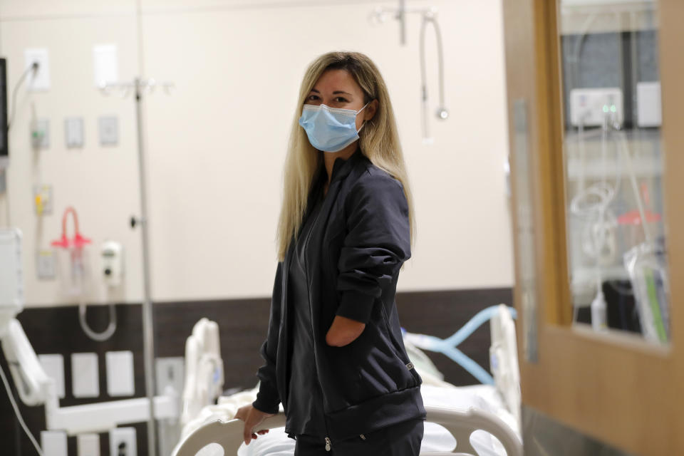 REMOVES REFERENCE OF AN AMPUTEE - Respiratory therapist Savannah Stuard, who was born without a left forearm, poses inside a simulation lab at Ochsner Medical Center in New Orleans, Tuesday, July 28, 2020. (AP Photo/Gerald Herbert)