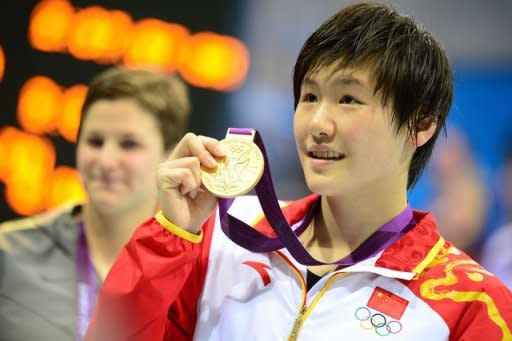 Gold medalist China's Ye Shiwen holds her medal after the podium ceremony of the women's 200m individual medley final during the swimming event at the London 2012 Olympic Games on July 31, 2012 in London