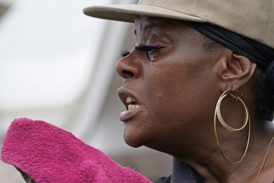 Rakisha Murray cries in relief as she arrives to see her mother's home largely undamaged, after she returned from evacuation with her mother and other family in Lake Charles, La., in the aftermath of Hurricane Laura, Sunday, Aug. 30, 2020. (AP Photo/Gerald Herbert)