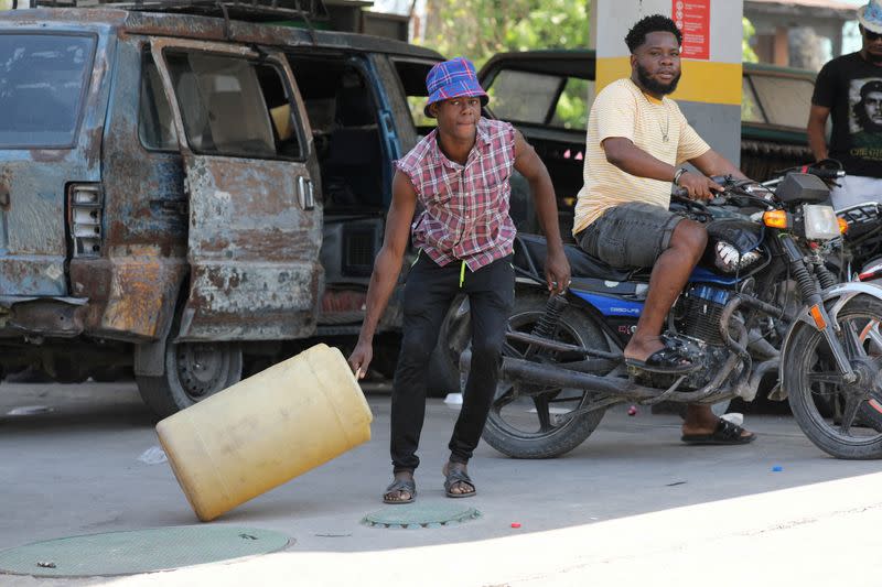 FILE PHOTO: People gather to buy gasoline at a petrol station in Port-au-Prince