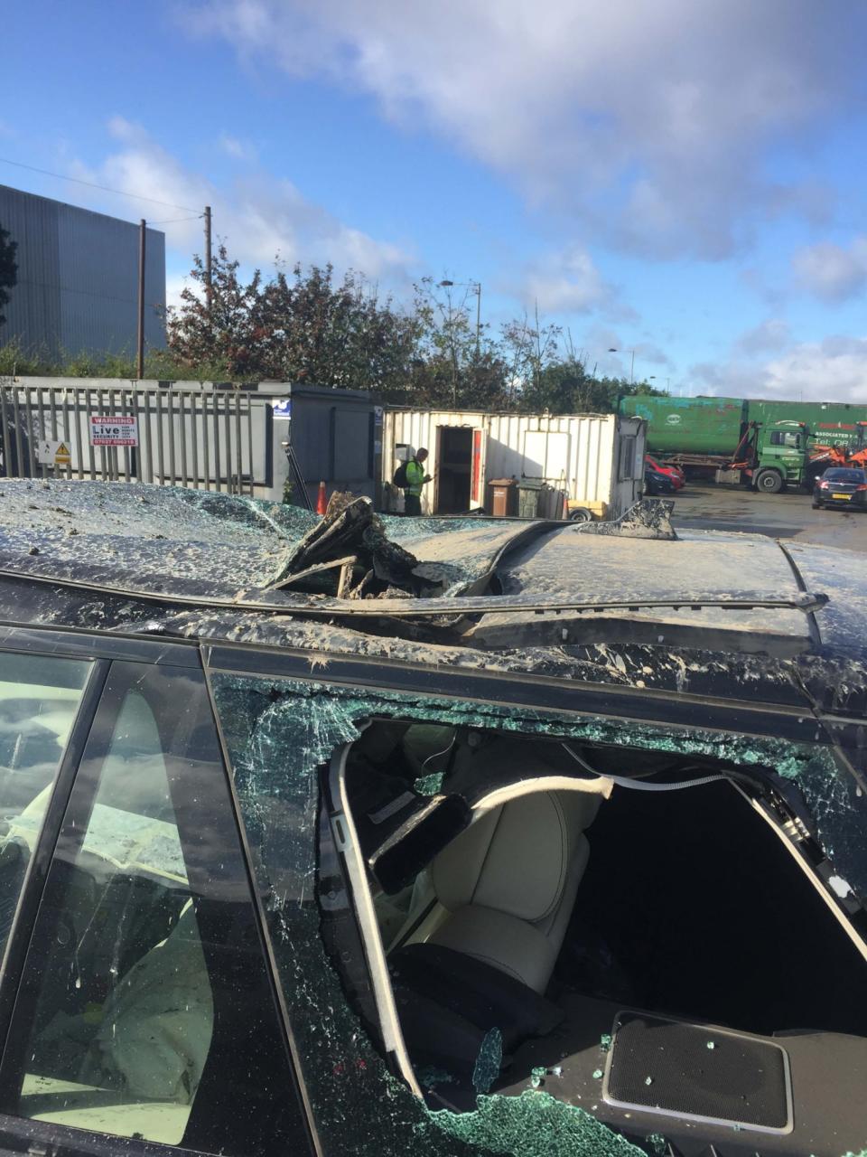 Damage to Thomas Crompton's Range Rover caused by an employee who went rogue with a 360 digger - 2nd October 2019 . See SWNS story SWLEdigger. This is the shocking moment a disgruntled worker in a digger went on the rampage at a demolition site - smashing his boss' Â£100,000 Range Rover and a truck. In a series of CCTV and mobile phone footage, the driver can be seen crashing into a black top-of-the-range 4x4 before wheeling off to pummel a second vehicle on Saturday morning (28 Sept). Staff at Thomas Crompton Demolition, Bradford, West Yorks., where then alerted to what was going on and rushed out to the vehicle to pull the man from the cab. Owner Thomas Crompton today (WED) told how they feared the employee was heading towards their fleet of 60 vehicles - valued at Â£6m pounds.