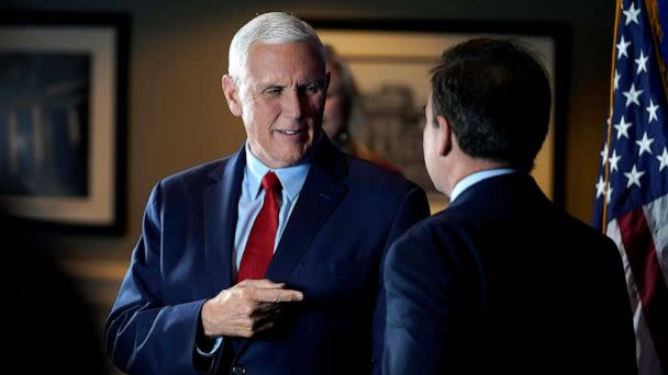 PHOTO: Former Vice President Mike Pence greets people while signing copies of his book 'So Help Me God' before the start of a GOP fundraising dinner, March 16, 2023, in Keene, N.H. (Steven Senne/AP)