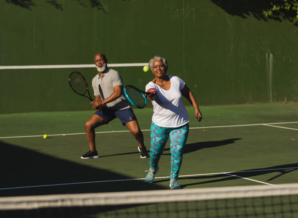 senior couple playing tennis