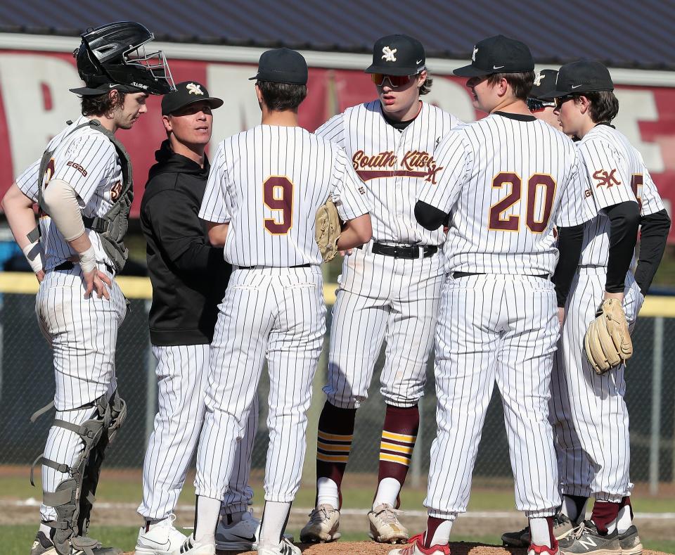 South Kitsap Wolves head coach Marcus Logue talks with his players on the field during their game against Graham-Kapowsin in Port Orchard, on April 4, 2023.