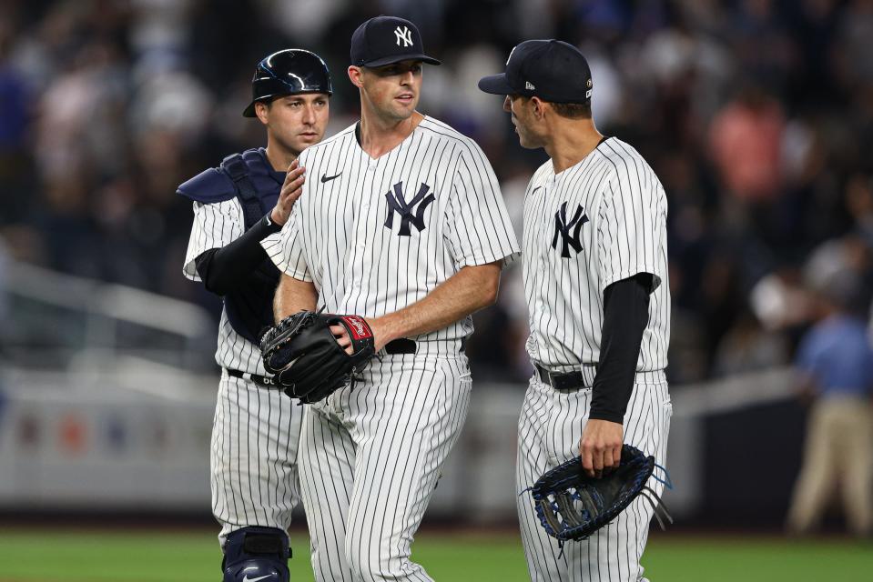 Yankees catcher Kyle Higashioka celebrates with relief pitcher Clay Holmes after a win.