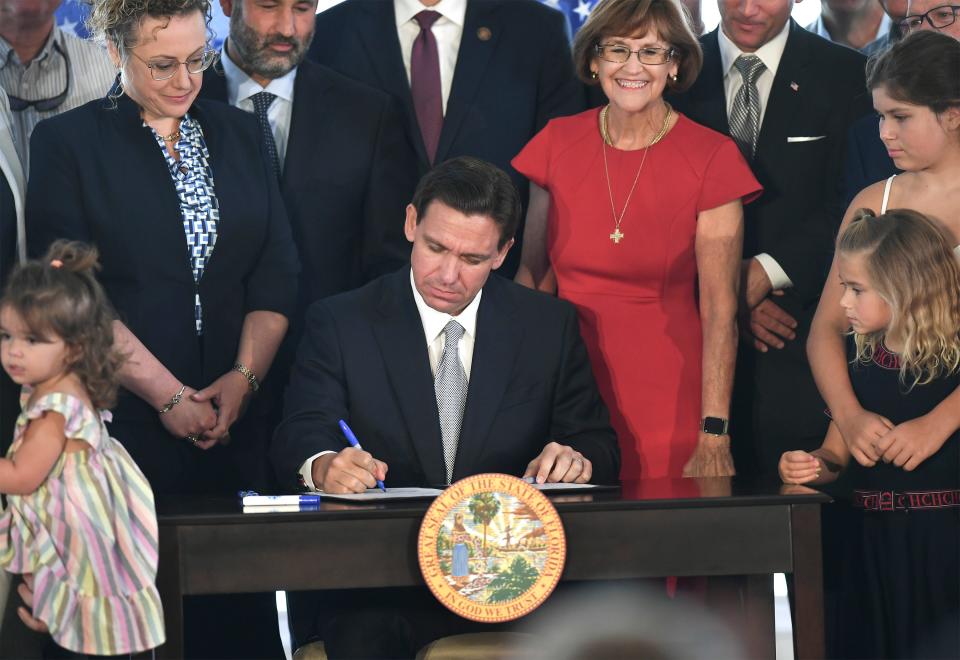 Florida Governor Ron DeSantis signs the Florida budget at the Pelican Yacht Club on Thursday June 15, 2023, in Fort Pierce.