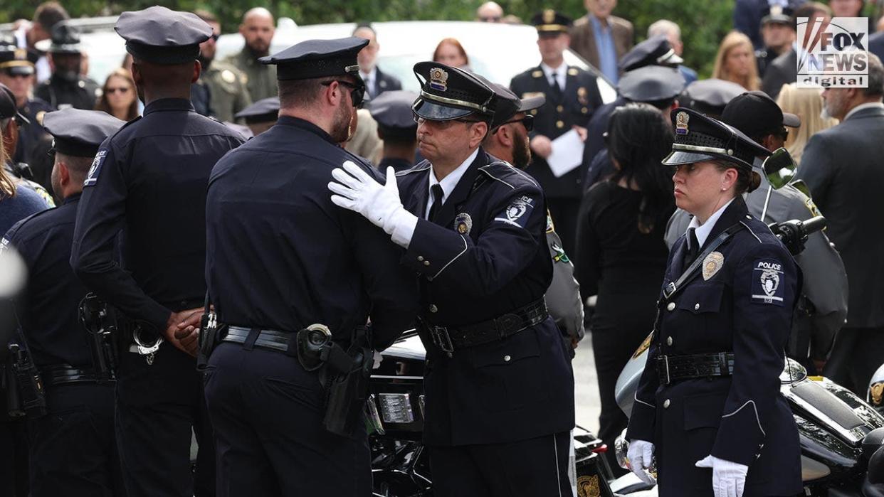 Police hug each other