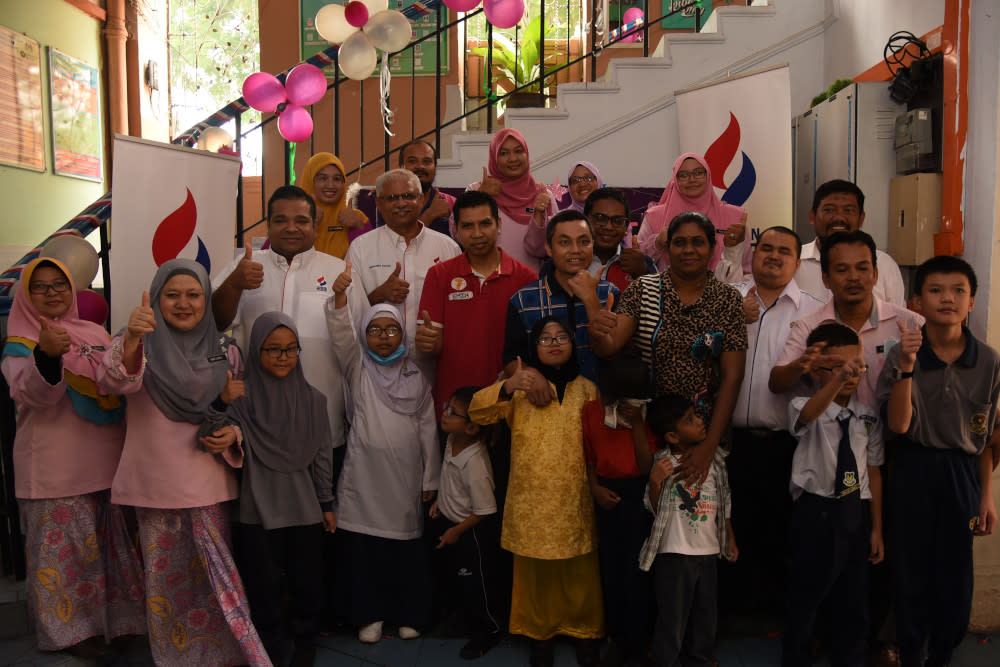 Trustees from Yayasan MRCB pose for a picture with teachers, parents and students at Sekolah Kebangsaan Pendidikan Khas Jalan Batu in KL during the handover ceremony. — Picture courtesy of Yayasan MRCB