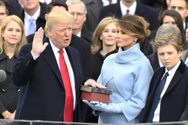 President Donald Trump takes his oath of office with his wife, Melania Trump, holding two bibles at the inauguration ceremony at the Capitol on January 20, 2017, in Washington, D.C. File Photo by Mike Theiler/UPI