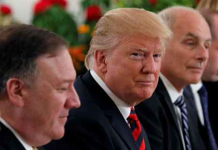 U.S. President Donald Trump flanked by Secretary of State Mike Pompeo and White House Chief of Staff John Kelly attend a lunch with Singapore's Prime Minister Lee Hsien Loong and officials at the Istana in Singapore June 11, 2018. REUTERS/Jonathan Ernst