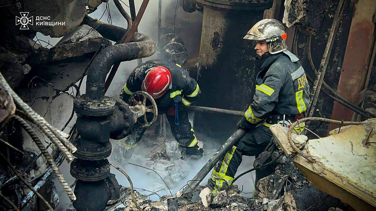 Ukrainian emergency services work to put out a fire after a Russian attack (AP)