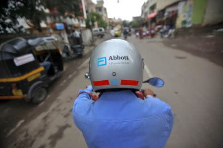 A representative for Abbott rides his motorcycle to a doctor's clinic in Pune, in this file picture taken August 27, 2012. REUTERS/Danish Siddiqui/Files