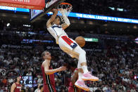 Washington Wizards forward Patrick Baldwin Jr. dunks over Miami Heat forward Nikola Jovic, bottom center left, during the first half of an NBA basketball game, Sunday, March 10, 2024, in Miami. (AP Photo/Lynne Sladky)