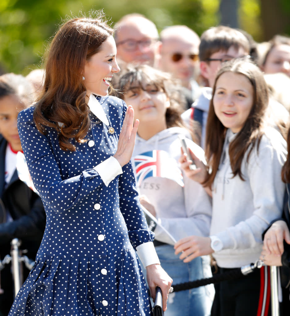 Kate Middleton waves to fans while wearing a Alessandra Rich dress.