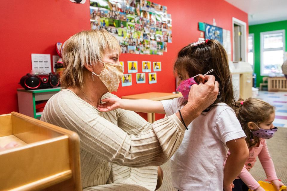 Donna Conklin, owner of the Pattycake Playhouse helps Scarlett Mack with her mask in the Pre-K 2-3-year-old classroom at Pattycake Playhouse Early Childhood Learning Center in Newburgh, NY on Monday, November 1, 2021. KELLY MARSH/FOR THE TIMES HERALD-RECORD