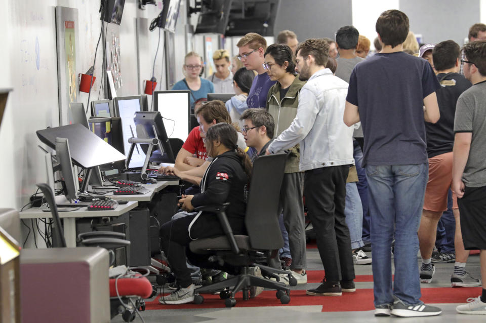 People play new video games during the Entertainment Arts and Engineering Program Launch event at the Master Games Studio on the University of Utah campus Wednesday, April 24, 2019, in Salt Lake City. Drones ferrying medical supplies, packages and even pizza could one day be crisscrossing the skies above U.S. cities, and a team at the University of Utah is working with regulators to keep that traffic in check using a video game. (AP Photo/Rick Bowmer)