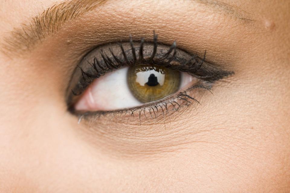 close up of a woman's eye with eyeliner and clumpy mascara