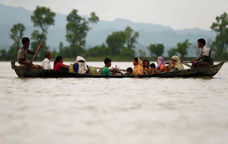 Rohingya refugees are seen on a boat as they are crossing border through the Naf river in Teknaf, Bangladesh, September 7, 2017. REUTERS/Mohammad Ponir Hossain