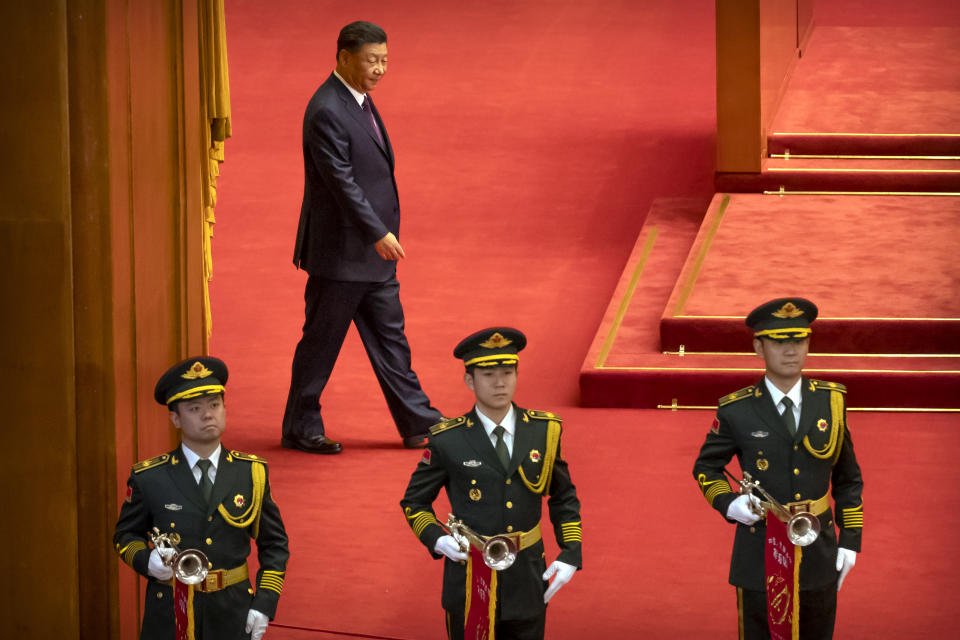 Chinese President Xi Jinping, rear, arrives for an event to honor some of those involved in China's fight against COVID-19 at the Great Hall of the People in Beijing, Tuesday, Sept. 8, 2020. Chinese leader Xi Jinping is praising China's role in battling the global coronavirus pandemic and expressing support for the U.N.'s World Health Organization, in a repudiation of U.S. criticism and a bid to rally domestic support for Communist Party leadership. (AP Photo/Mark Schiefelbein)