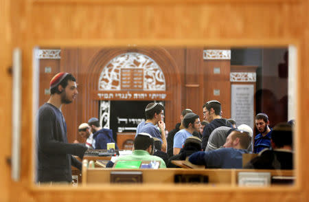 Jewish seminary students are seen through a window at a Yeshiva in Israeli settlement of Bet El in the occupied West Bank January 30, 2017. Picture taken January 30, 2017. REUTERS/Ronen Zvulun