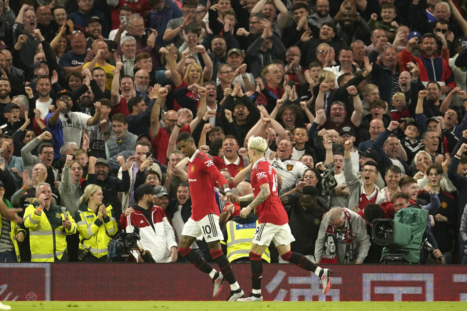 Manchester United's Marcus Rashford, left, celebrates after scoring his side's fourth goal during the English Premier League soccer match between Manchester United and Chelsea at the Old Trafford stadium in Manchester, England, Thursday, May 25, 2023. (AP Photo/Dave Thompson)