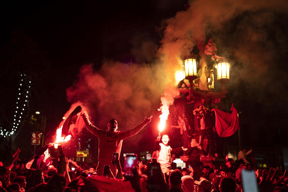 Morocco fans celebrate in Barcelona, Spain, Tuesday, Dec. 6, 2022. Morocco beat Spain on penalties in a round of 16 World Cup soccer tournament in Qatar. (AP Photo/Pau de la Calle)