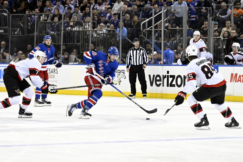 New York Rangers left wing Jimmy Vesey (26) skates between Ottawa Senators left wing Brady Tkachuk (7) and defenseman Jake Sanderson (85) during the second period of an NHL hockey game Monday, April 15, 2024, at Madison Square Garden in New York. (AP Photo/Bill Kostroun)