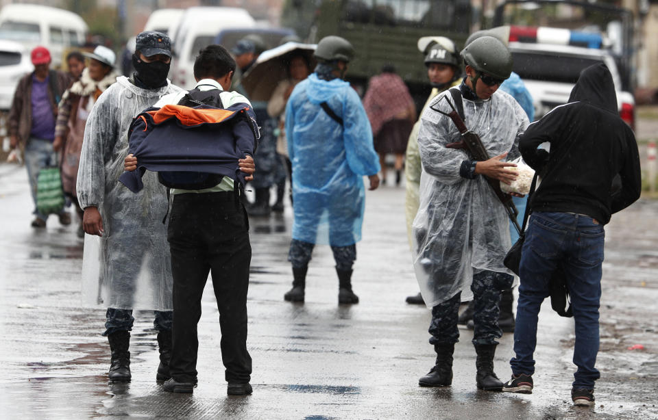 Soldiers check people going to Cochabamba, in Sacaba, Bolivia, Thursday, Nov. 14, 2019. Evo Morales, Bolivia’s first indigenous president, resigned on Sunday at military prompting, following massive nationwide protests over suspected vote-rigging in an Oct. 20 election in which he claimed to have won a fourth term in office. An Organization of American States audit of the vote found widespread irregularities. (AP Photo/Juan Karita)