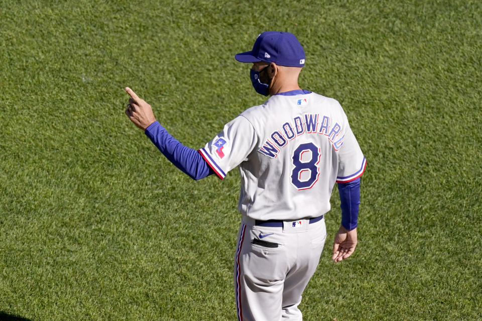 Texas Rangers manager Chris Woodward motions for a pitching change during the first inning of a baseball game against the Kansas City Royals Thursday, April 1, 2021, in Kansas City, Mo. (AP Photo/Charlie Riedel)