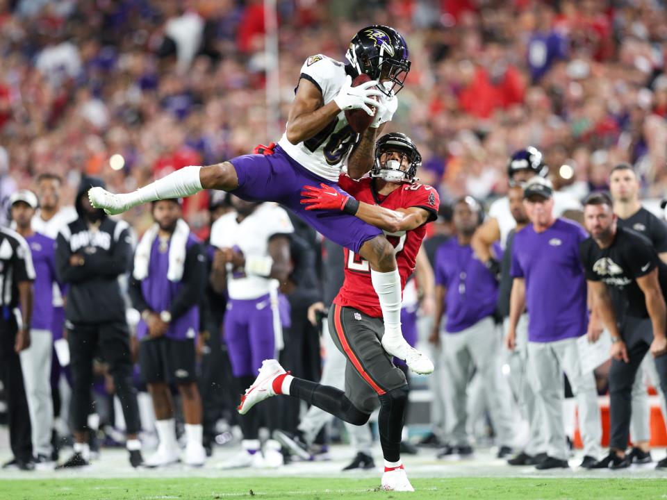 Baltimore Ravens wide receiver Demarcus Robinson (10) catches a pass while defended by Tampa Bay Buccaneers cornerback Zyon McCollum.