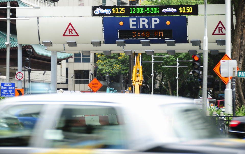 An Electronic Road Pricing (ERP) gantry reflecting the rates and busy traffic in Orchard Road, Singapore.