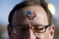 Rob Ordman, of Calgary Alberta, wears the slogan "Boston Strong" on his head near the finish line before the start of 118th Boston Marathon Monday, April 21, 2014 in Boston. He's supporting his wife Beth, who is running in the race. (AP Photo/Charles Krupa)