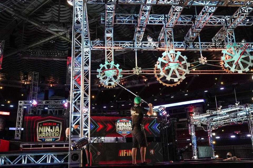 In this exclusive photo, an 'American Ninja Warrior' crew member helps prepare a huge obstacle course set up inside the Dome at America's Center in St. Louis for Season 12 of the NBC athletic competition.