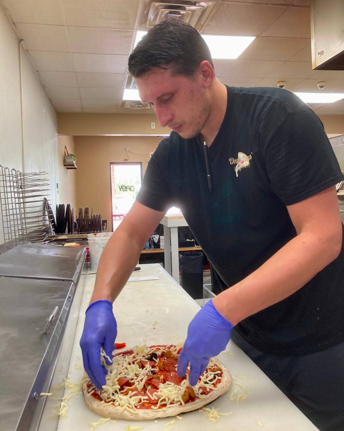 Shaun Brown, makes a pizza from scratch at Dough Bros’ PIzza Joint in Warner Robins. He’ll be the district manager when the Dough Bros’ Pizza Joint at 3955 Arkwright Road, Suite E, in Macon opens Friday.