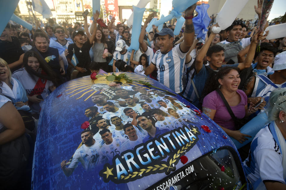 Argentina soccer fans celebrate their team's victory over Croatia at the end of the team's World Cup semifinal match in Qatar after watching it on TV in Buenos Aires, Argentina, Tuesday, Dec. 13, 2022. (AP Photo/Gustavo Garello)