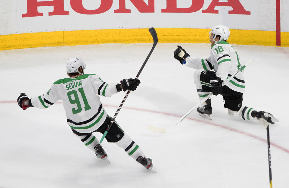 Dallas Stars center Joe Pavelski (16) celebrates his goal against the Tampa Bay Lightning with teammate Tyler Seguin (91) during the third period of Game 5 of the NHL hockey Stanley Cup Final, Saturday, Sept. 26, 2020, in Edmonton, Alberta. (Jason Franson/The Canadian Press via AP)