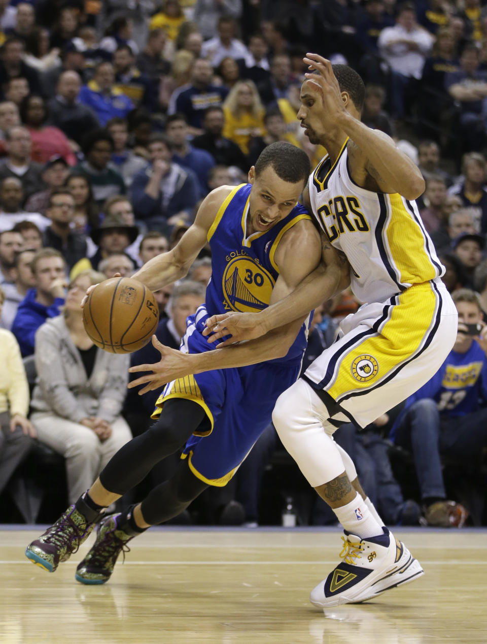 Golden State Warriors' Stephen Curry (30) goes to the basket against Indiana Pacers' George Hill (3) during the first half of an NBA basketball game Tuesday, March 4, 2014, in Indianapolis. (AP Photo/Darron Cummings)