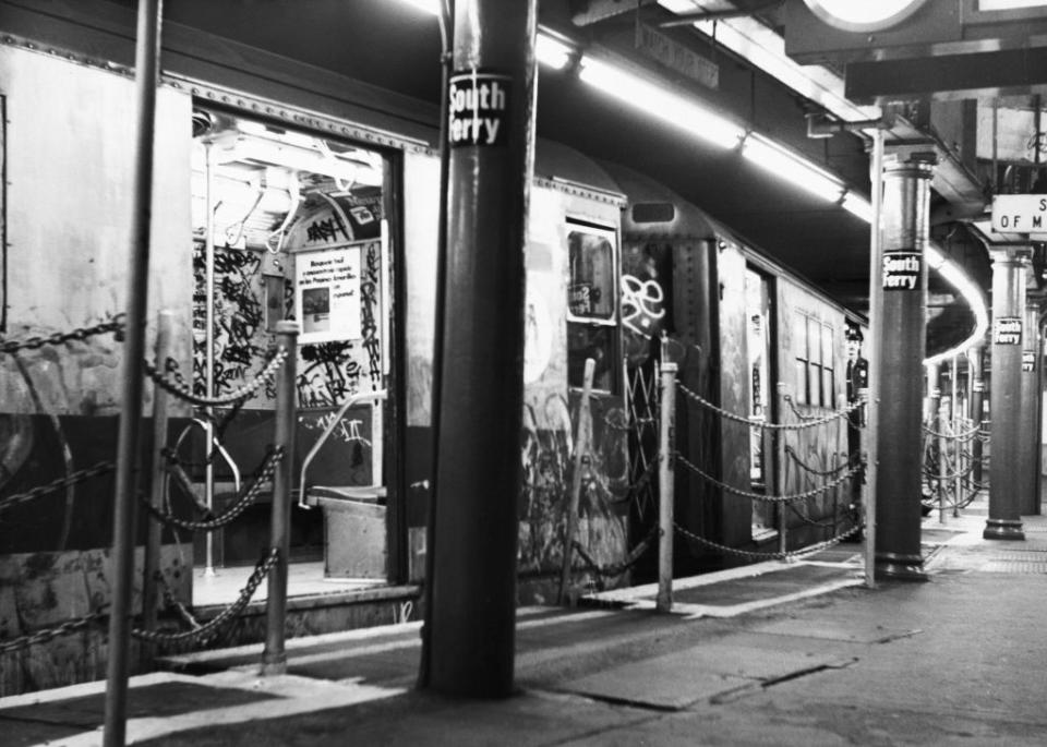 A graffiti-covered NYC Subway train, its doors open at South Ferry Subway station in the Financial District of Lower Manhattan in New York City, 1983. (Credit: Peter Keegan/Keystone/Hulton Archive via Getty Images)