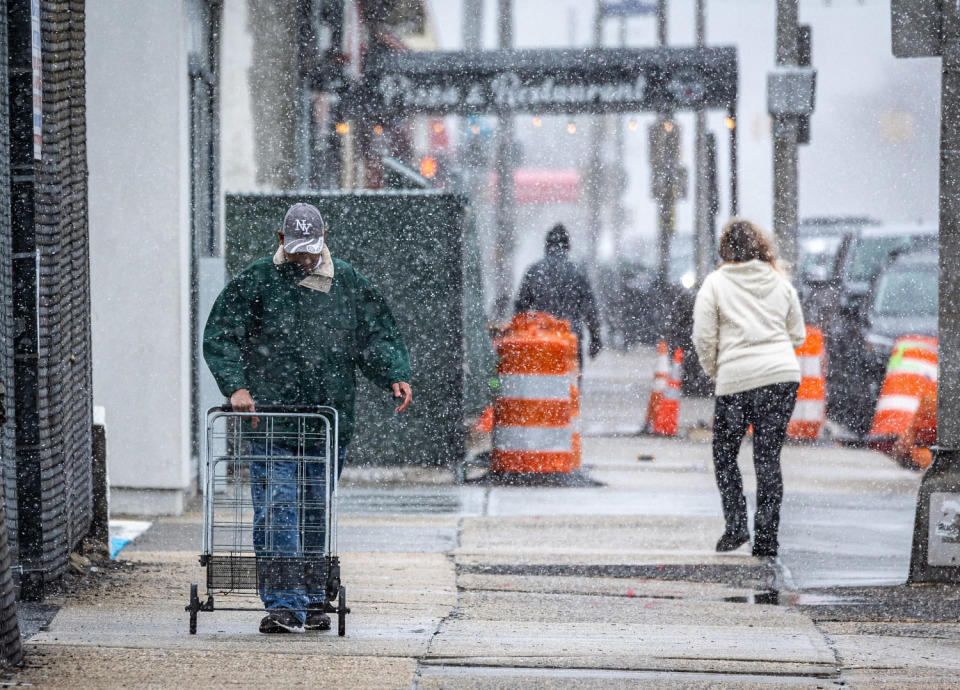 People navigate a city street during a snow storm. (J. Conrad Williams Jr. / Newsday RM via Getty Images file)