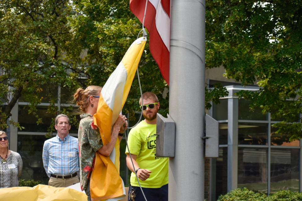 City staff places the Disability Flag on Wauwatosa City Hall's flagpole. The flag will be raised all week in recognition of the passage of the Americans with Disabilities Act of 1990.