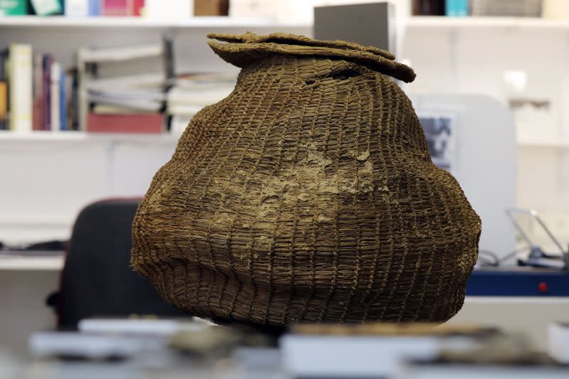 An ancient complete basket, part of various artefacts recently discovered in the Judean Desert caves along with scroll fragments of an ancient biblical texts, is seen during an event for media at Israel Antiquities Authority laboratories in Jerusalem