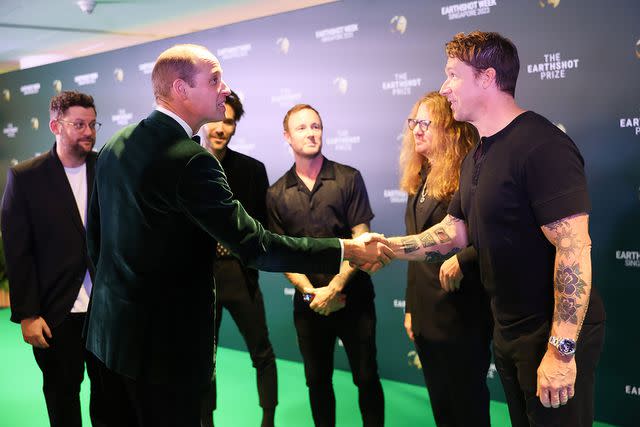 <p>Chris Jackson/Getty</p> Prince William chats with members of OneRepublic backstage at the 2023 Earthshot Prize Awards Ceremony in Singapore.