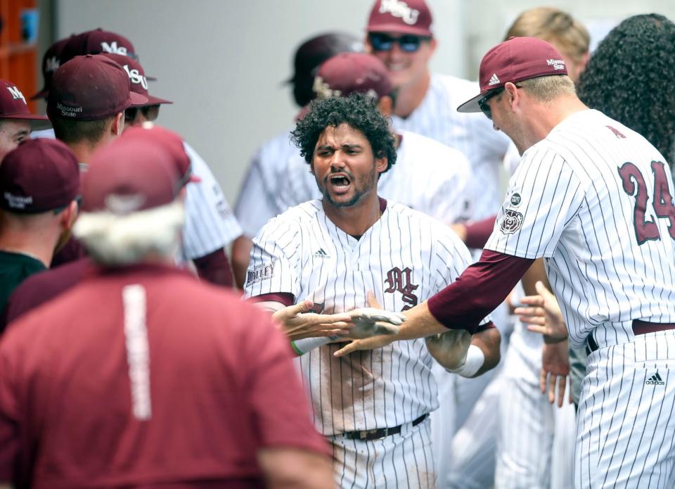 Missouri State's Cam Cratic, center, celebrates with teammates after hitting a grand slam against Oklahoma State in the second inning during an NCAA college baseball tournament regional game Sunday, June 5, 2022, in Stillwater, Okla. (Ian Maule/Tulsa World via AP)