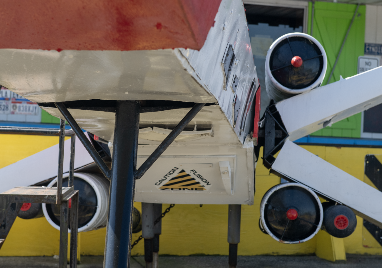 An X-wing starfighter is displayed in front of Mike's Place in Kent. Beer kegs were used for the engines.