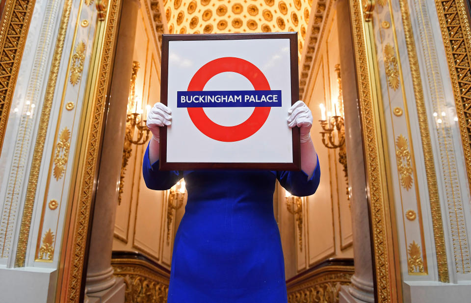 Sally Goodsir, Assistant Curator of Decorative Arts, holds a London Underground sign presented to Queen Elizabeth which forms one of the exhibits on the theme of Royal Gifts which goes on show from July 22 at the Summer Opening of the State Rooms at Buckingham Palace, London, Britain, April 3, 2017.  REUTERS/Toby Melville