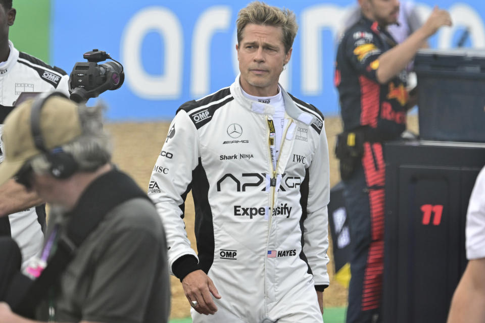 Actor Brad Pitt walks through the paddock before before the British Formula One Grand Prix race at the Silverstone racetrack, Silverstone, England, Sunday, July 9, 2023. Production of Brad Pitt and Lewis Hamilton's F1 movie has begun at Silverstone. (Christian Bruna/Pool photo via AP)