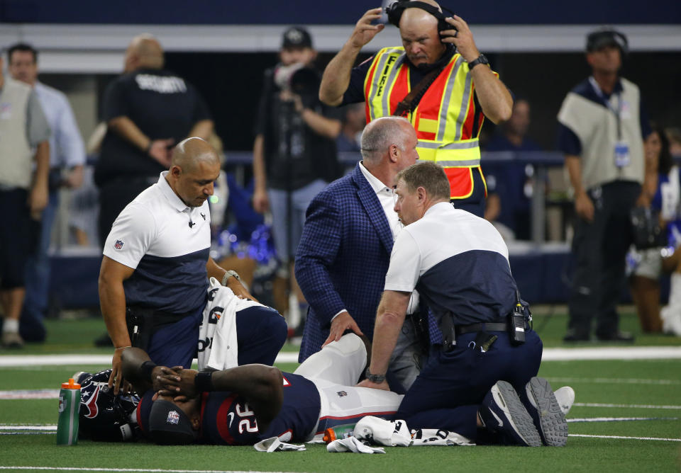 Houston Texans staff checks on running back Lamar Miller (26) after he suffered an injury against Dallas. (AP)