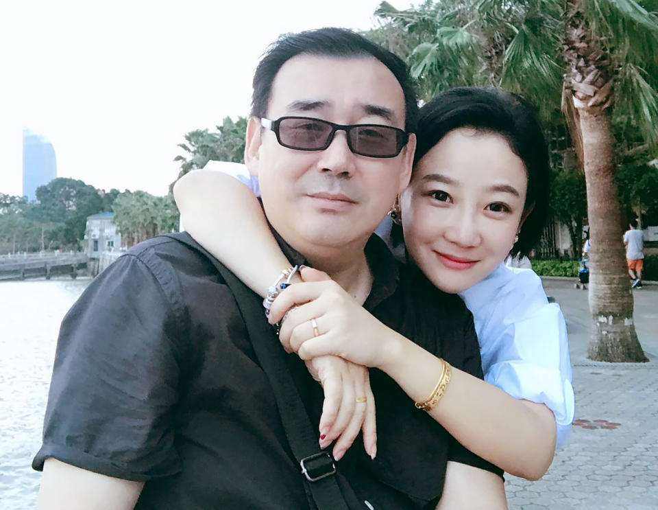 In this 2017 photo provided by his family, Yang Hengjun, left, poses with his family member in Beijing. Australia's Foreign Minister Marise Payne said on Friday, July 19, 2019, her government was "deeply disappointed" that the Chinese-Australian writer was placed in criminal detention in Beijing six months after he was taken into custody at a Chinese airport. (Yang Family Photo via AP)