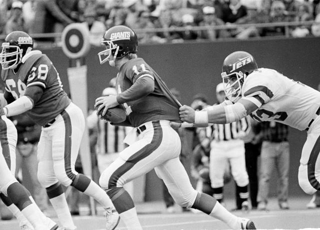 Defensive end Mark Gastineau of the New York Jets throws his hands in