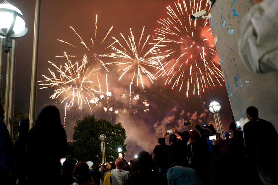 People watch as fireworks light the sky during the 2023 Ford Fireworks along the Detroit River at Hart Plaza in downtown Detroit on Monday, June 26, 2023.